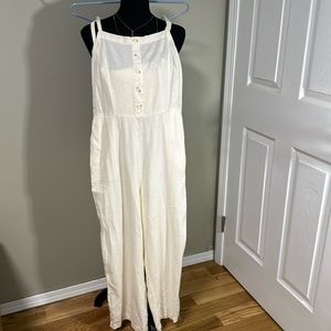 Adorable jumpsuit. New with tags. Elastic ruffle backing. Off white in color.